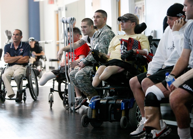 Service members involved in physical therapy at the Brooke Army Medical Center in San Antonio wait for President Bush to visit, Nov. 8, 2007. (AP Photo/Gerald Herbert)